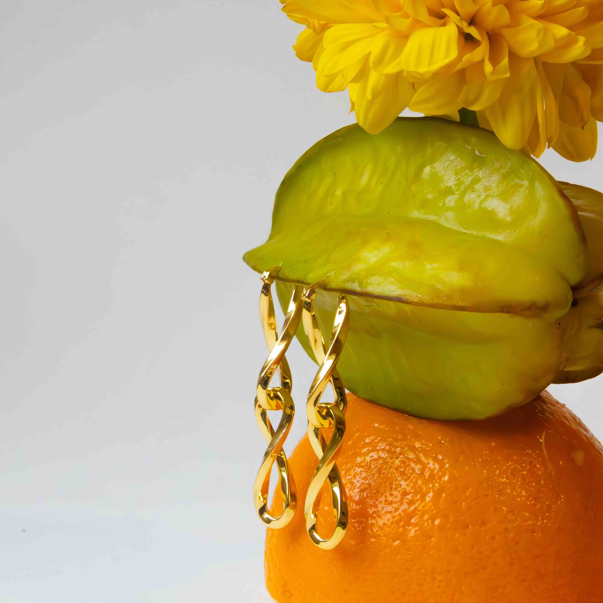 Gold Double Infinity Link Hoop & Drop Earrings on exotic fruit